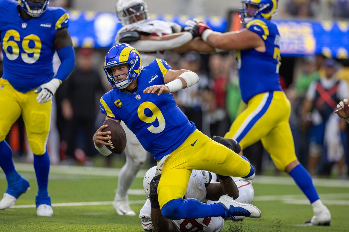 Rams quarterback Matthew Stafford is tackled by Arizona Cardinals defensive end Kevin Strong.