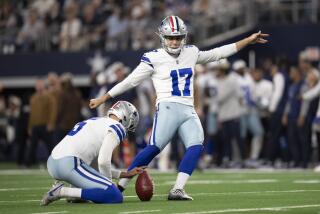 Dallas Cowboys' Brandon Aubrey (17), iwht Bryan Anger holding, kicks an extra point.