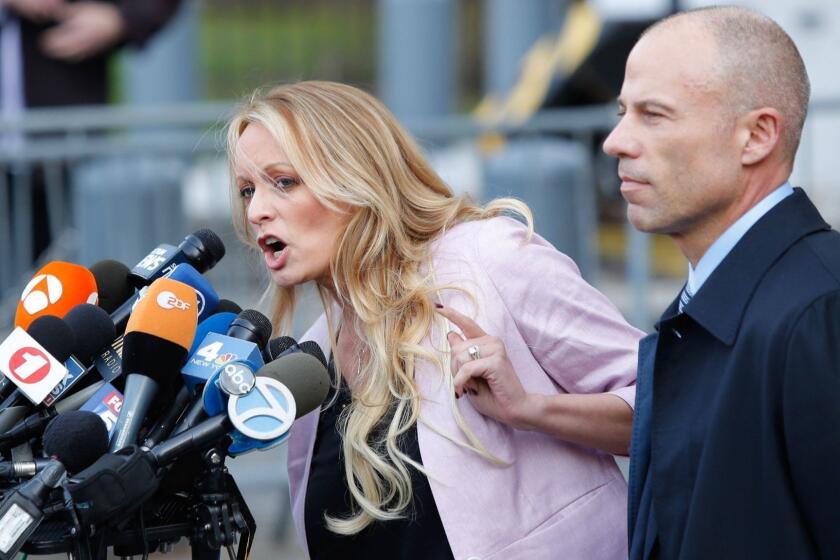 (FILES) In this file photo taken on April 16, 2018 adult-film actress Stephanie Clifford, also known as Stormy Daniels speaks outside US Federal Court with her lawyer Michael Avenatti (R) in Lower Manhattan, New York. Adult film star Stormy Daniels filed a defamation suit on April 30, 2018 against US President Donald Trump for a tweet in which he dismissed a composite sketch that Daniels says depicted a man who threatened her in 2011. / AFP PHOTO / EDUARDO MUNOZ ALVAREZEDUARDO MUNOZ ALVAREZ/AFP/Getty Images ** OUTS - ELSENT, FPG, CM - OUTS * NM, PH, VA if sourced by CT, LA or MoD **