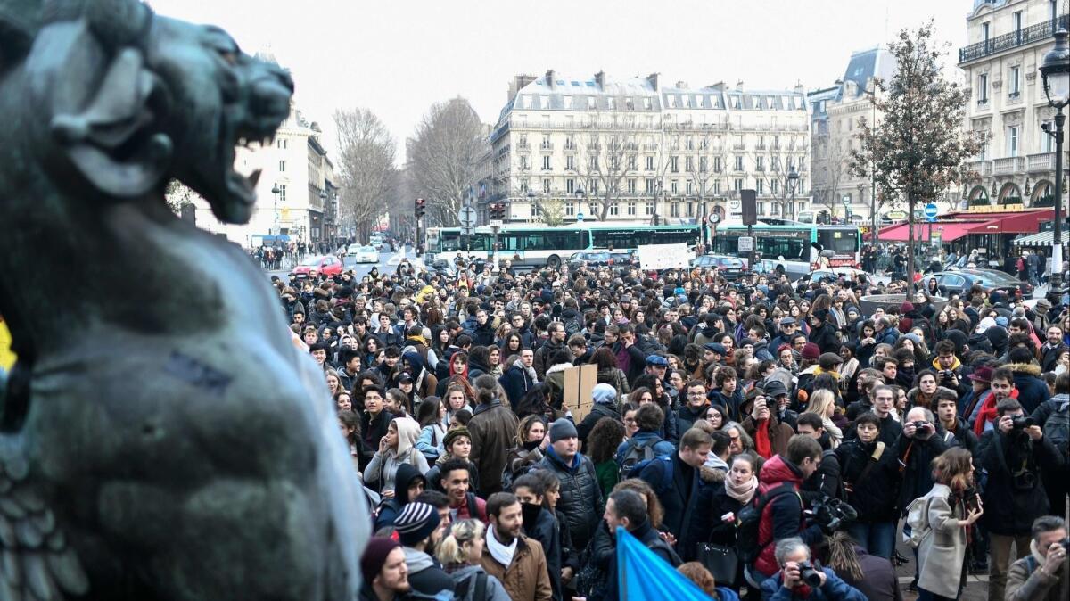 High school students, teachers and parents fill Place Saint-Michel in Paris on Tuesday to protest education reforms.