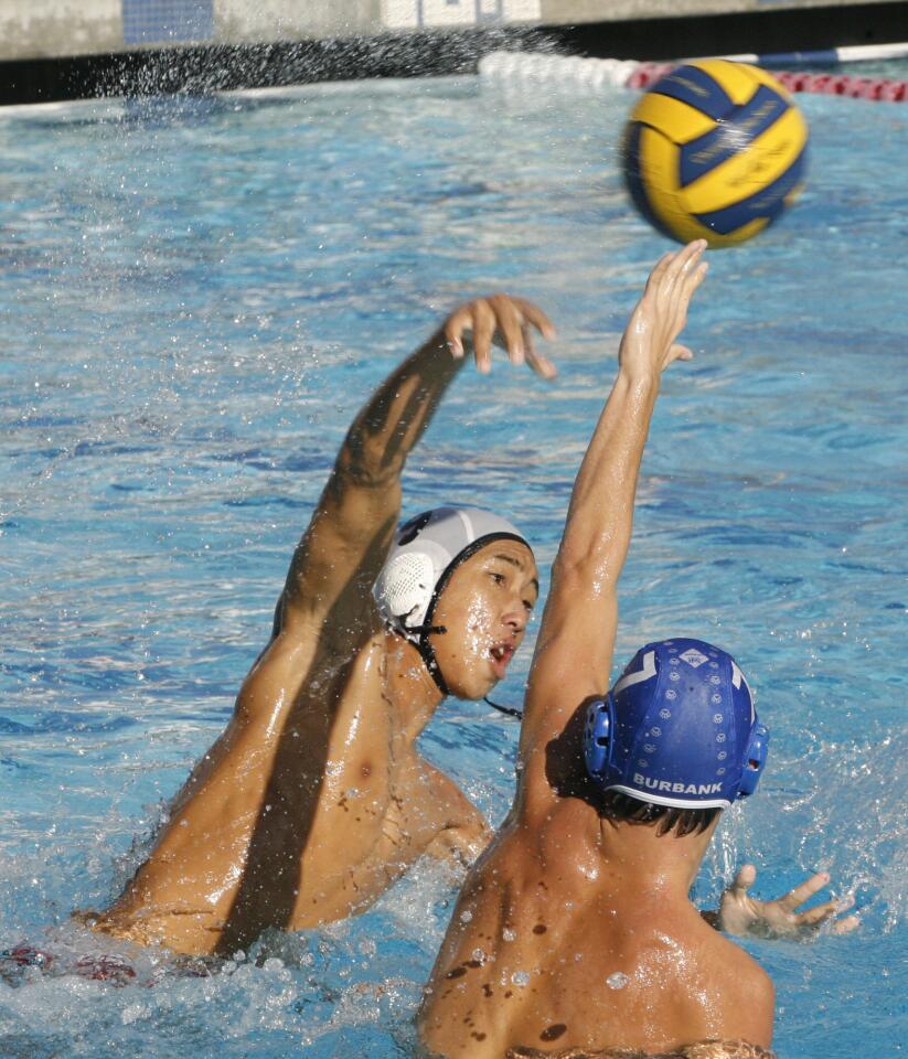 Burroughs' Casey Ueno, 9, shoots the ball past Burbank defender Dion Costa, 7, on Wednesday, October 26, 2011.
