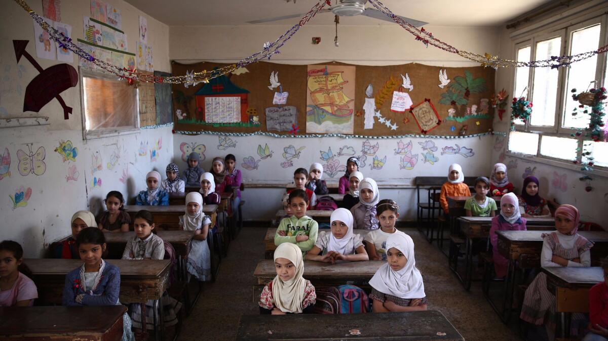 Syrian schoolgirls sit at their classroom at the Saif al-Dawla school in Douma in May. (Abd Doumany / AFP / Getty Images)