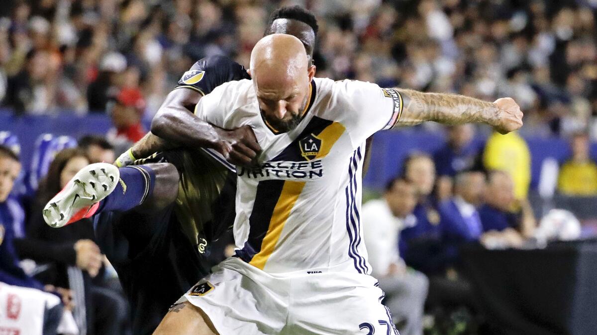 Galaxy defender Jelle Van Damme, right, battles Philadelphia Union forward C.J. Sapong for the ball in a game on April 29. The Galaxy are about to agree to a deal sending Van Damme home to Belgium.