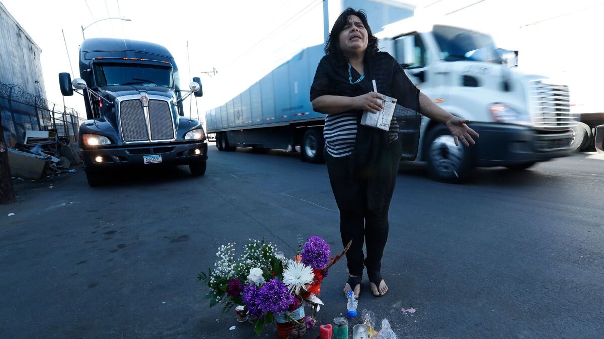 Aileen Kemper shows where a hit-and-run driver struck and killed her mother on the street near the RV they shared in Boyle Heights. Large trucks drive along the street throughout the day.