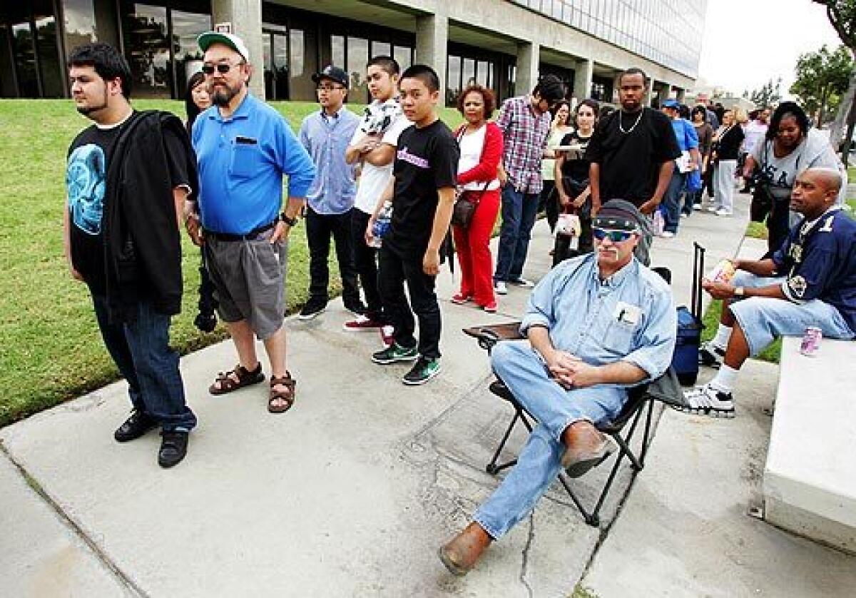 Bill Morgan takes a seat while other early voters stand in line Saturday at the Los Angeles County registrar's office in Norwalk. About 2,000 people have voted each day since early balloting began Oct. 25, a registrar spokeswoman said.