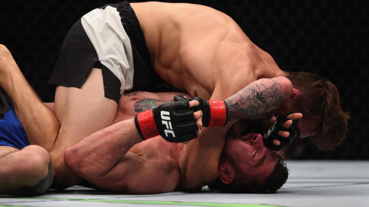 Niko Price (top) attempts to submit Brandon Thatch during their welterweight bout at UFC 207.