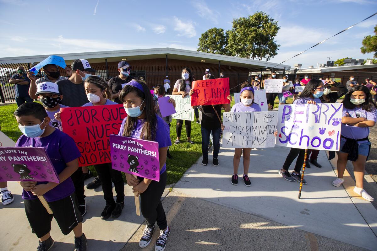 Students and family members protest the closing of Perry Elementary School in Huntington Beach on Tuesday.