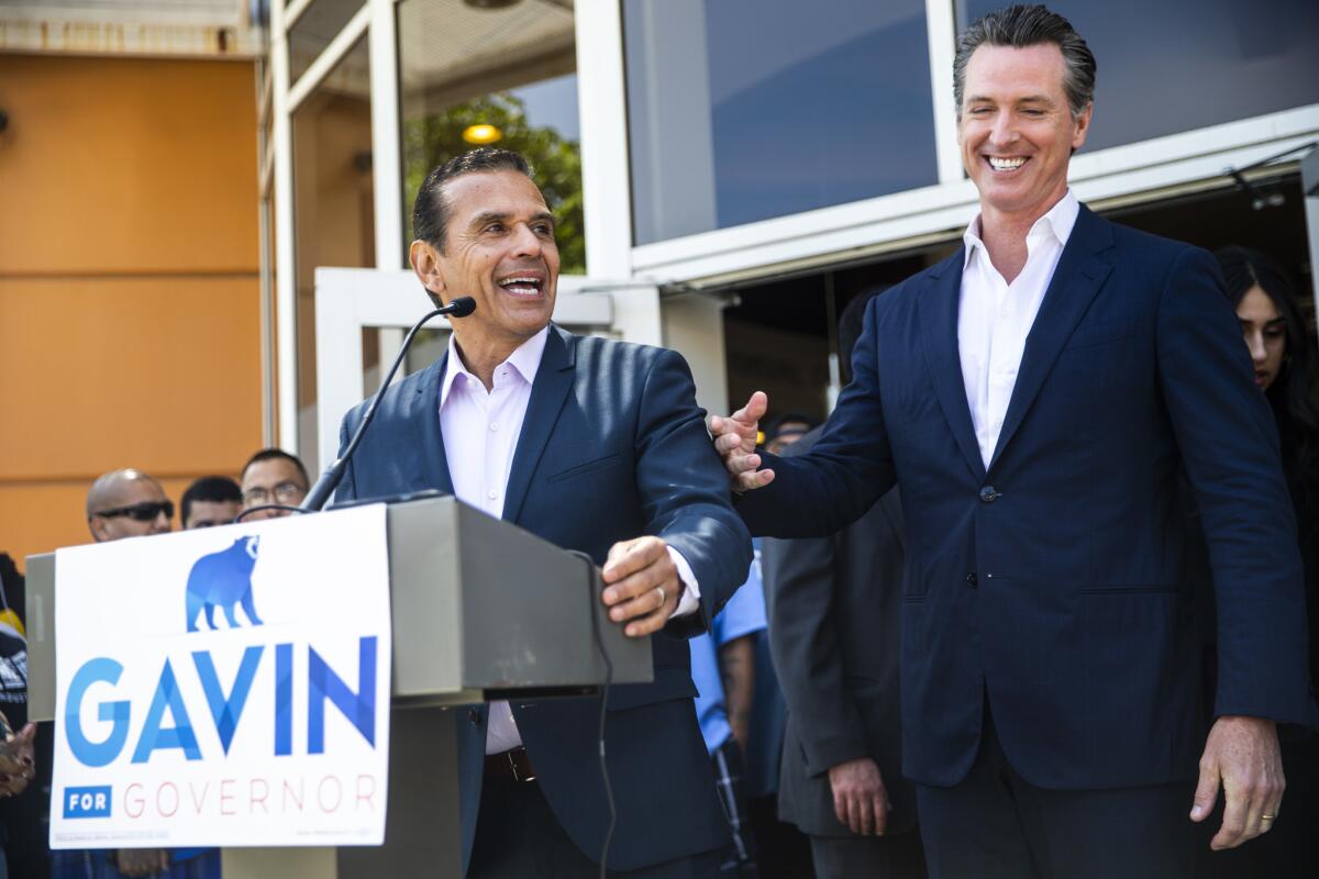Former L.A. Mayor Antonio Villaraigosa, at the microphone, with then-Lt. Gov. Gavin Newsom, right, in 2018. 