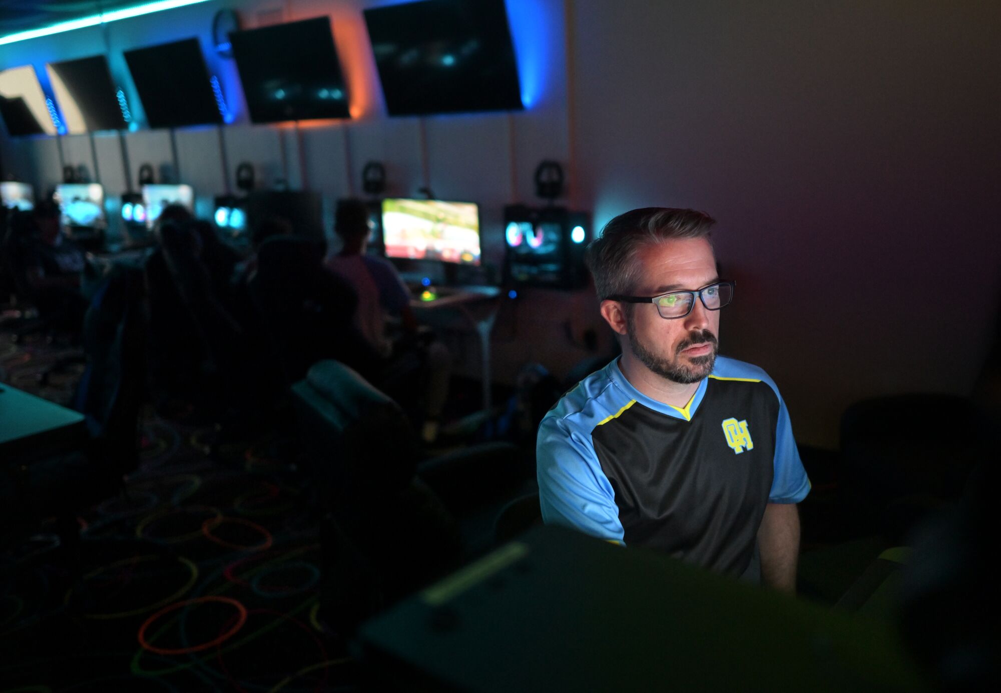 Esports coach Tim Fields works on a computer before a competition at Quartz Hill High School.