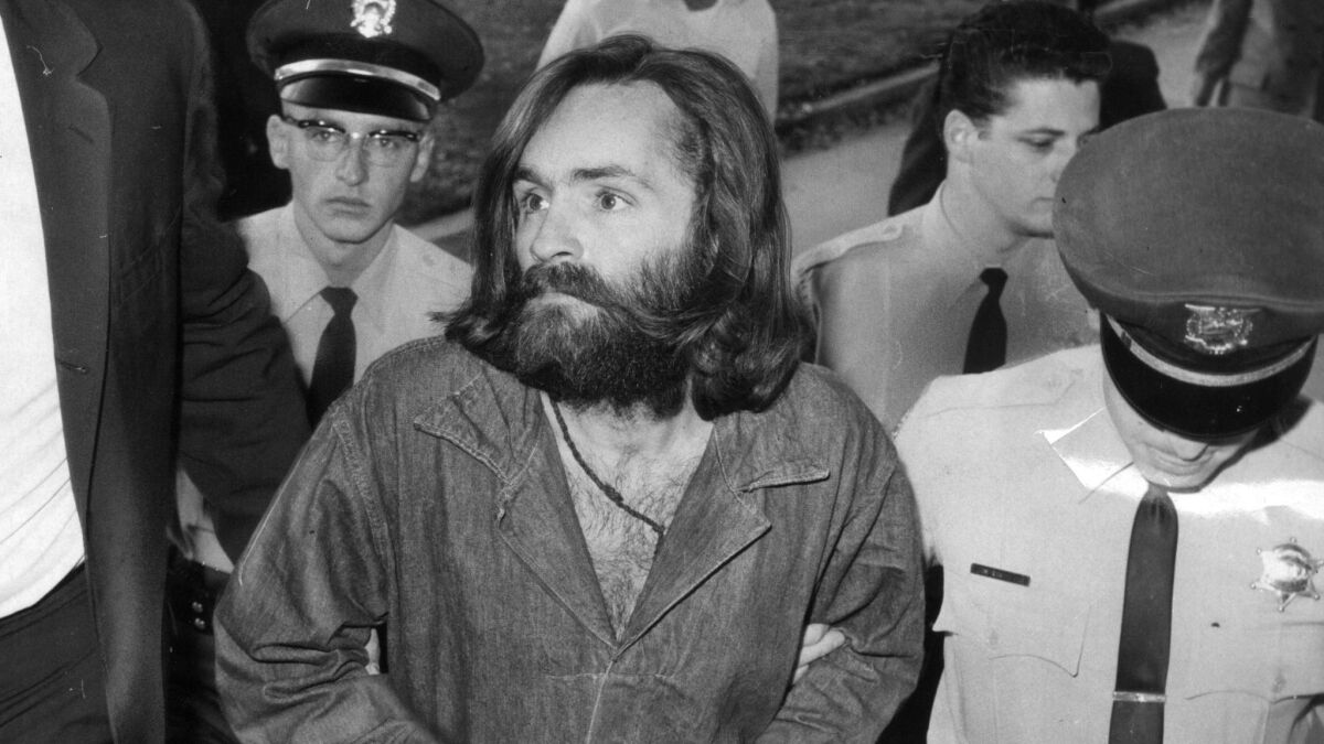 Charles Manson is escorted to court for a preliminary hearing in December 1969.