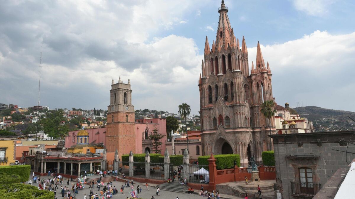 Tourists at the main square in front of the San Miguel Arcangel cathedral in San Miguel de Allende, Mexico.