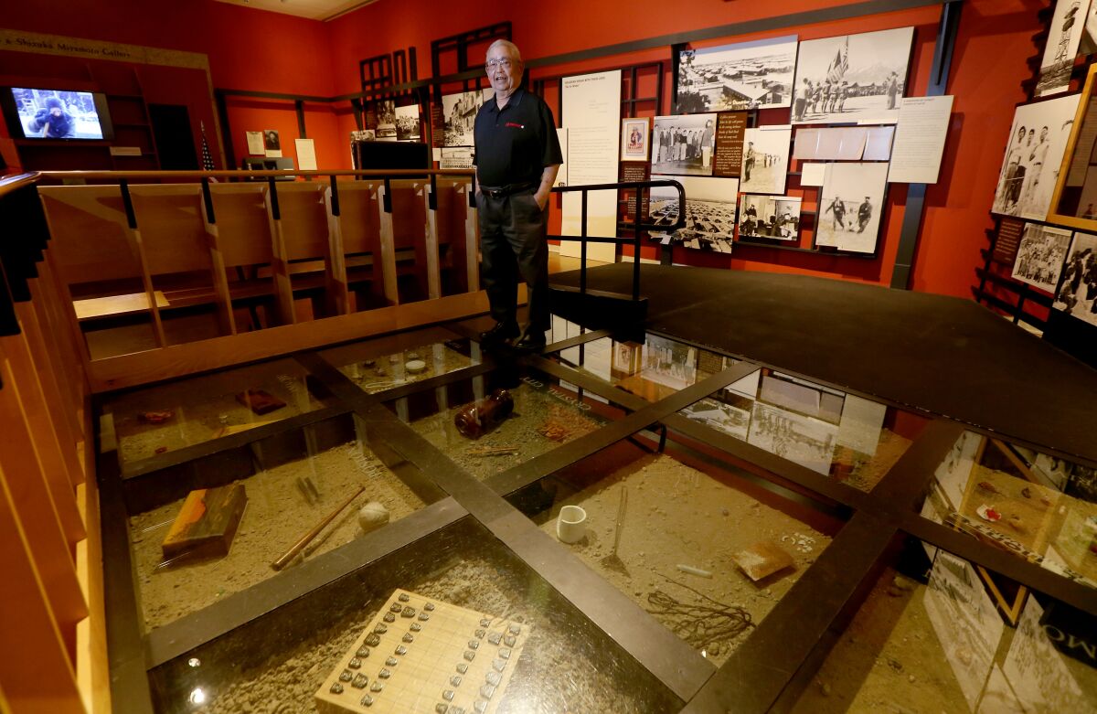Richard Murakami with a display of soil and artifacts from  internment camps