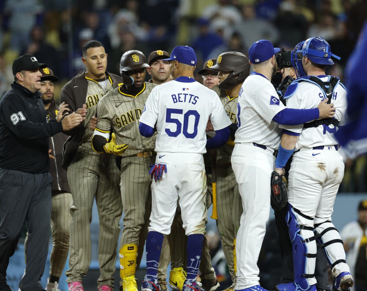 Dodgers and Padres players meet at home plate after the benches cleared during the fifth inning Saturday night.