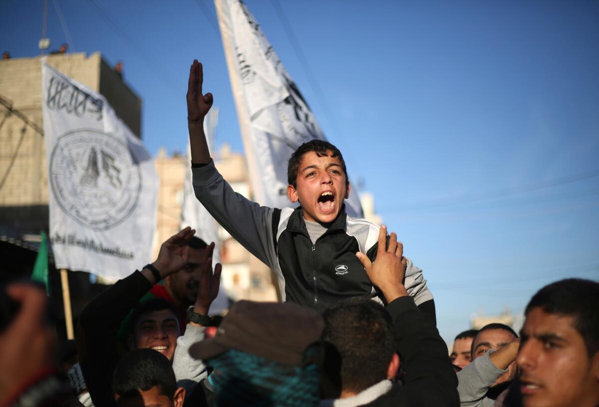 A Palestinian boy shouts slogans Feb. 5 during a rally near the Rafah border between southern Gaza Strip and Egypt to condemn the decision of an Egyptian court to ban the armed wing of Hamas.