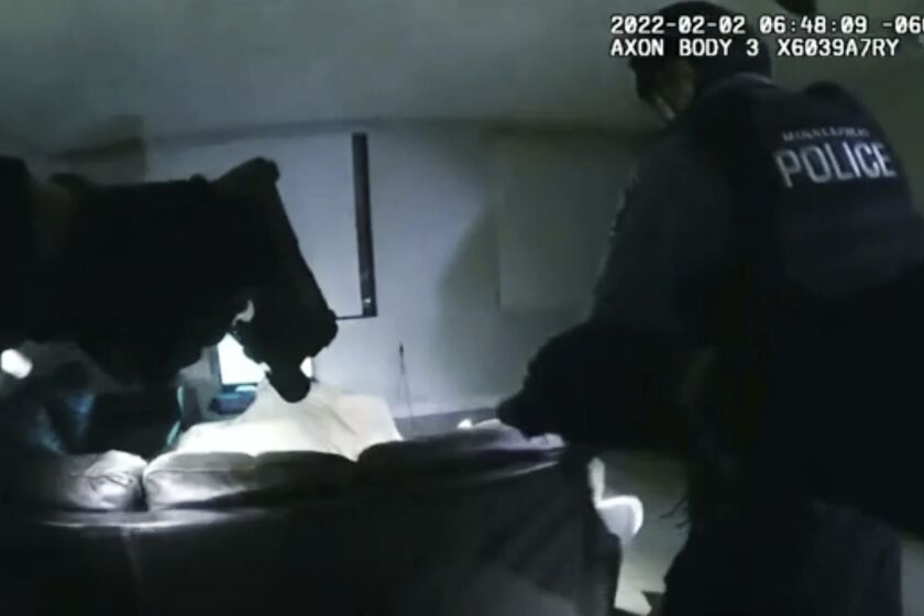FILE - In this image taken from Minneapolis Police Department body camera video and released by the city of Minneapolis, Minneapolis police enter an apartment on Wednesday, Feb. 2, 2022, moments before shooting 22-year-old Amir Locke. The parents of Amir Locke, who was killed by a Minneapolis police officer when a SWAT team executed a no-knock search warrant one year ago, are suing the city and the officer, Friday, Feb. 3, 2023. (Minneapolis Police Department via AP)