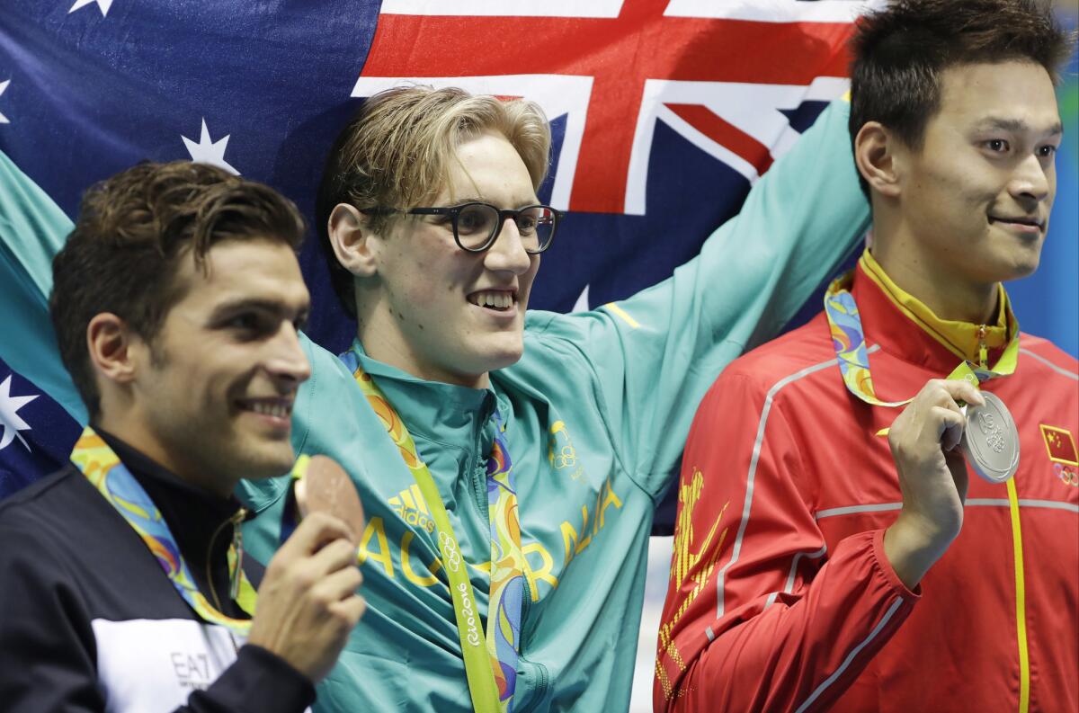 Winner Australia's Mack Horton, center, third-place Italy's Gabriele Detti, left, and second-place China's Sun Yang hold their medals after the men's 400-meter freestyle during the swimming competitions at the 2016 Summer Olympics, Saturday, Aug. 6, 2016, in Rio de Janeir