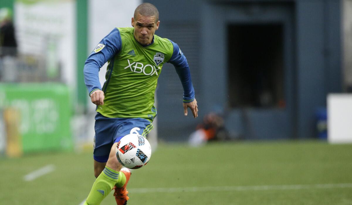 Seattle Sounders' Osvaldo Alonso dribbles against Sporting Kansas City in the first half of a match on March 6.