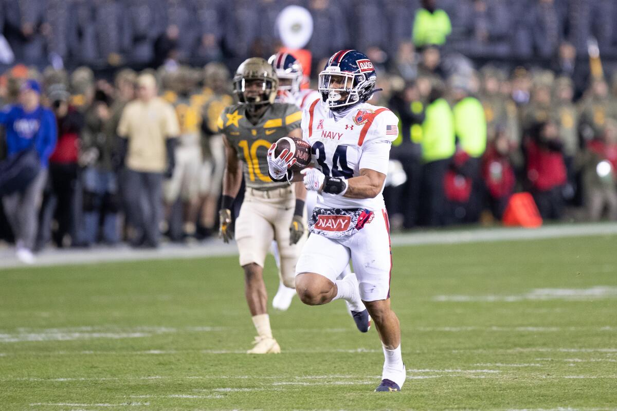 Navy fullback Anton Hall Jr. rushes for a 77-yard touchdown against Army on Dec. 10, 2022, at Lincoln Financial Field.