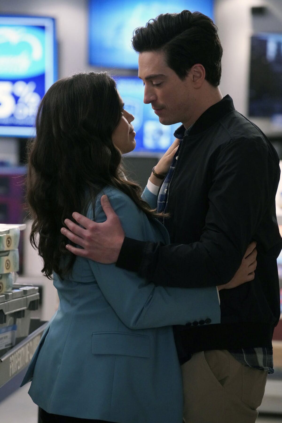 Amy (Ferrera) and Jonah (Feldman) embrace and look into each other's eyes on "Superstore."