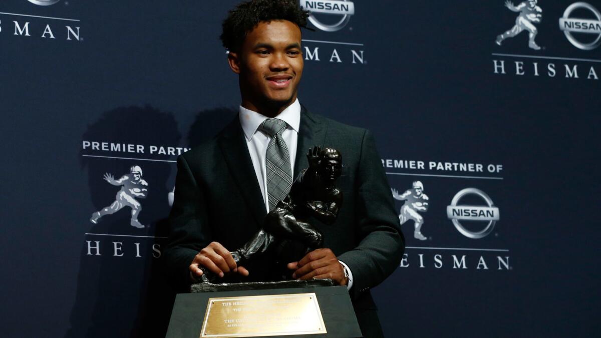 Oklahoma quarterback Kyler Murray poses with the Heisman Trophy after the presentation ceremony on Saturday in New York.