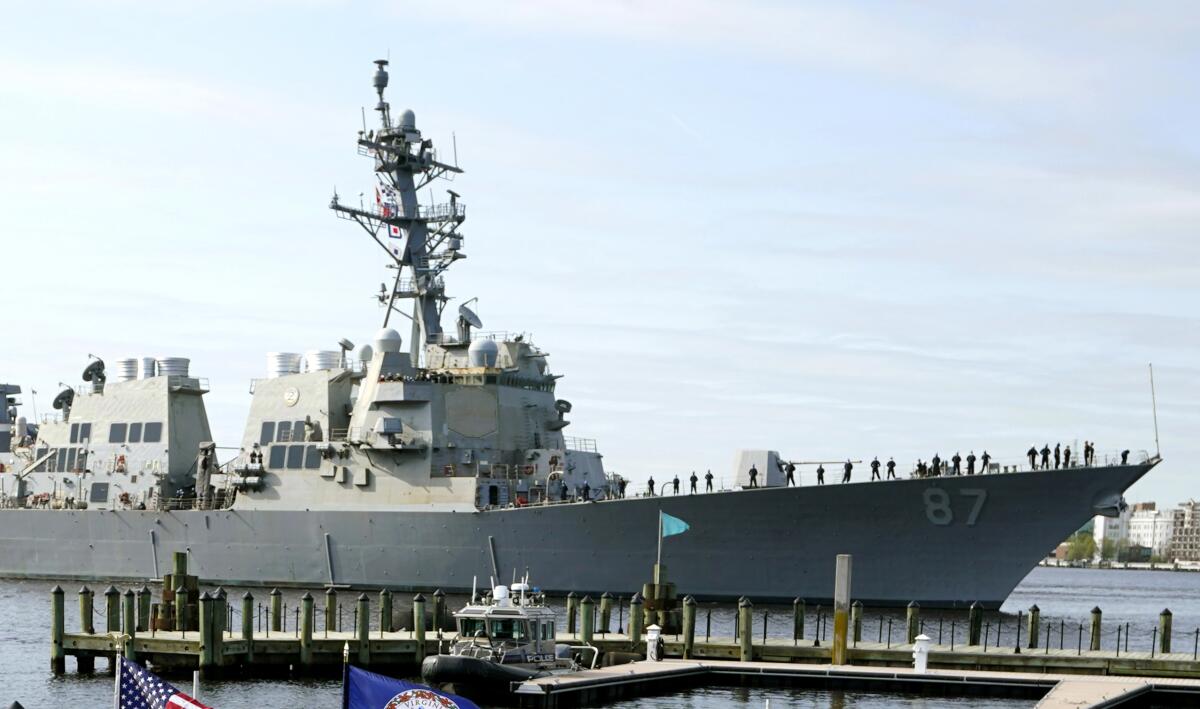 The USS Mason passes a dock in Norfolk, Va.