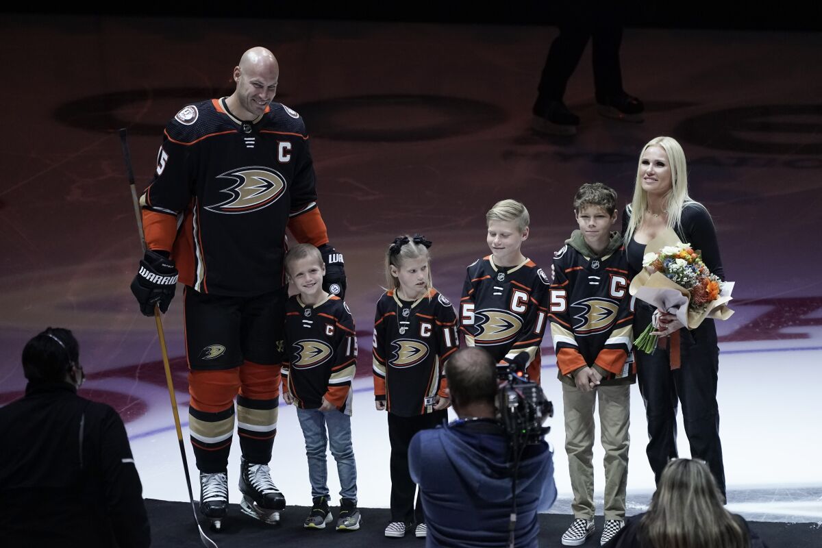 Ducks' Ryan Getzlaf and his family stand for a photo during a pre-game ceremony.