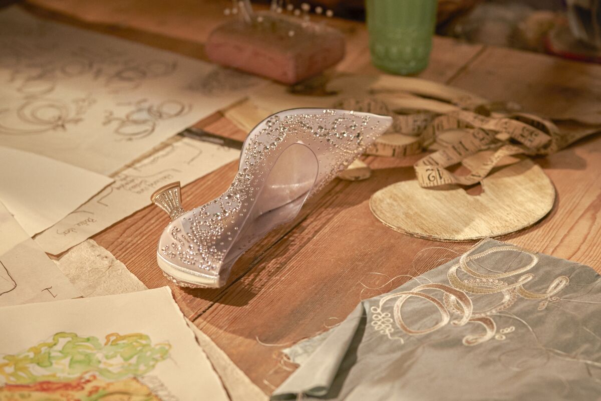A bedazzled glass slipper on a hardwood floor