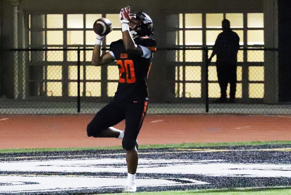 Huntington Beach's Musashi Ray (20) celebrates after scoring a touchdown against Marina on Thursday.