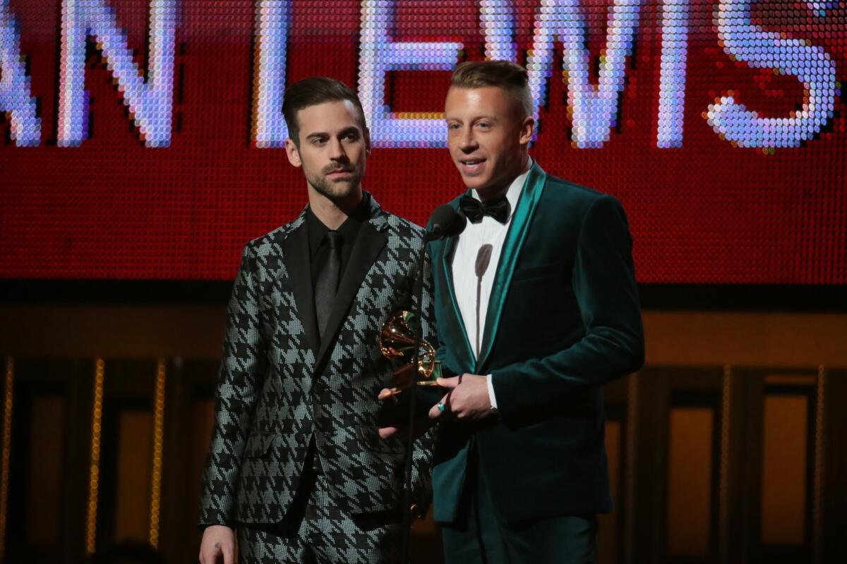 Ryan Lewis, left, and Macklemore accept the Grammy for new artist at the 56th Annual Grammy Awards at Staples Center in Los Angeles on Jan. 26, 2014.