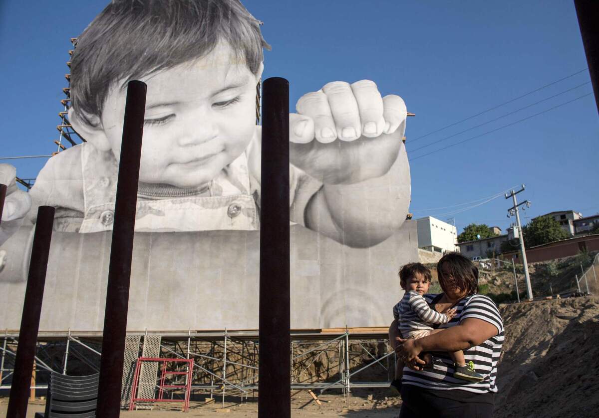 Lissy and her son Enrique Achondo, who served as a model for JR for his artwork installed on the U.S.-Mexico border. (Guillermo Arias / AFP/Getty Images)