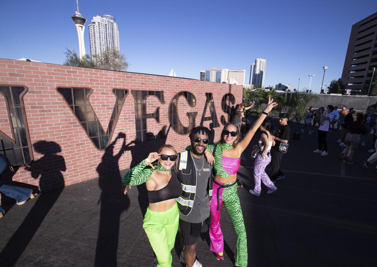 Fans pose in front of the Day N Vegas sign  