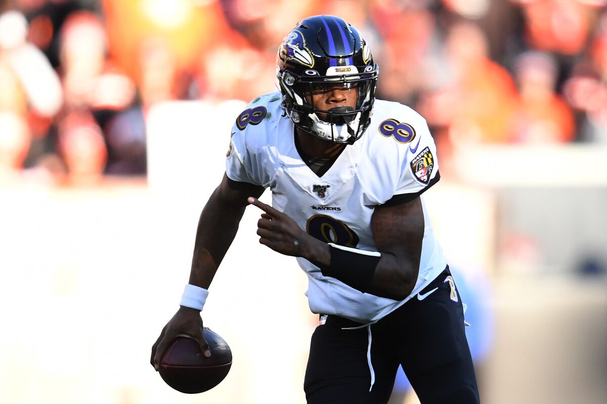 Ravens quarterback Lamar Jackson runs with the ball.