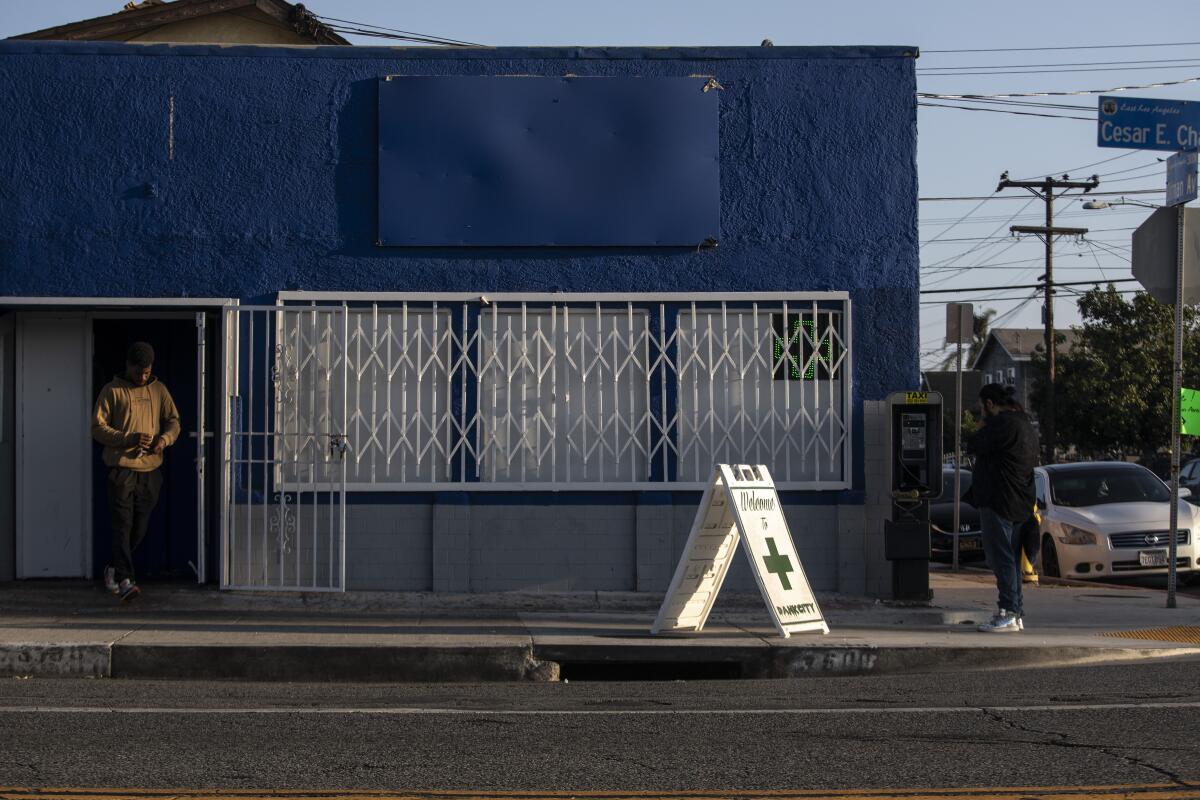 A man leaves a blue and white building