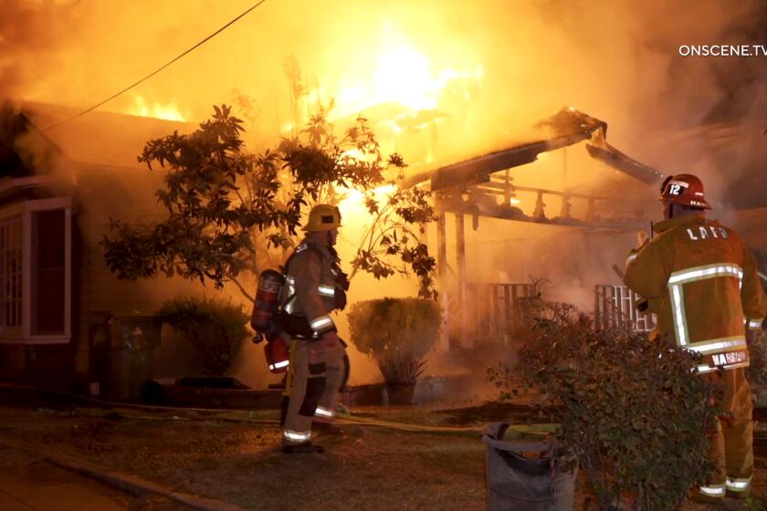 Firefighters arrive at a Highland Park home engulfed in flames. 
