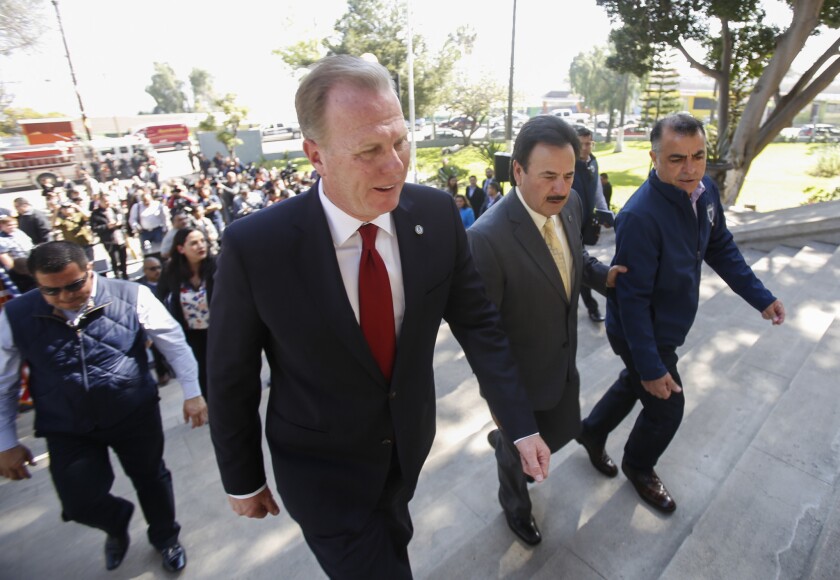 San Diego Mayor Kevin Faulconer, on the left, and Tijuana Mayor Juan Manuel Gastelum, center, walk into the historic Casa de la Cultura in Tijuana on March 13.