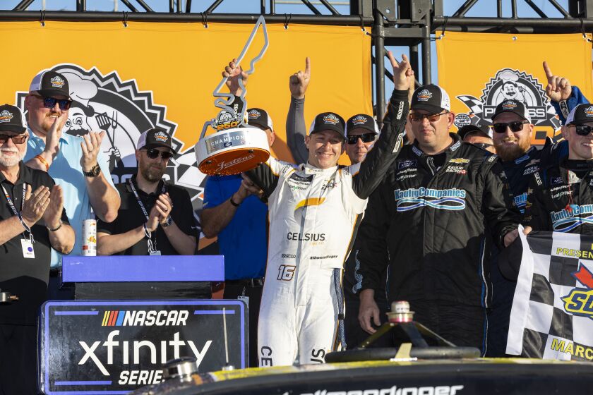 AJ Allmendinger, center, celebrates after winning a NASCAR Xfinity Series auto race at Circuit of the Americas, Saturday, March 25, 2023, in Austin, Texas. (AP Photo/Stephen Spillman)