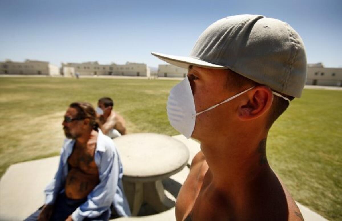 Inmates at Pleasant Valley State Prison in Coalinga, Calif., wear masks to protect against valley fever. Federal health officials say they will work with Central Valley physicians to conduct a clinical trials aimed at finding ways to treat the disease.