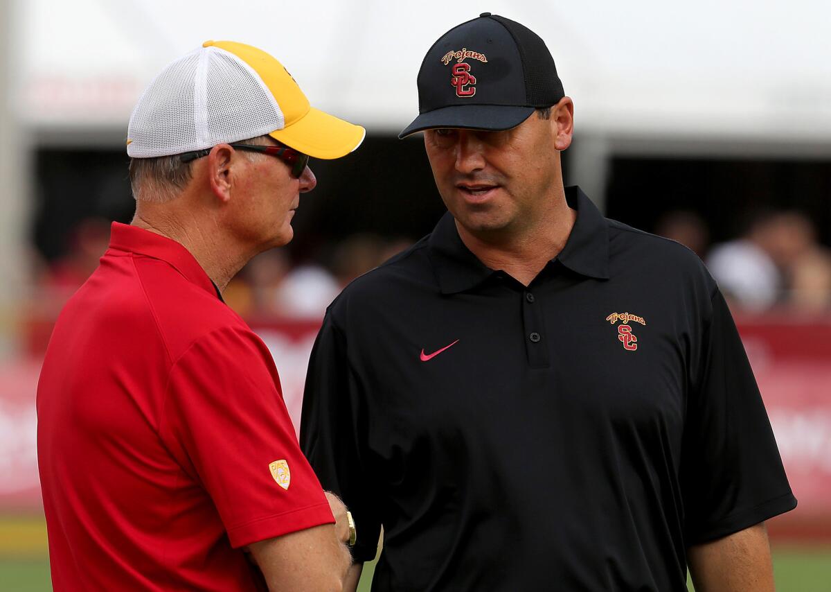 USC Coach Steve Sarkisian, right, taks with Athletic Director Pat Haden before a game against Idaho on Sept. 12.