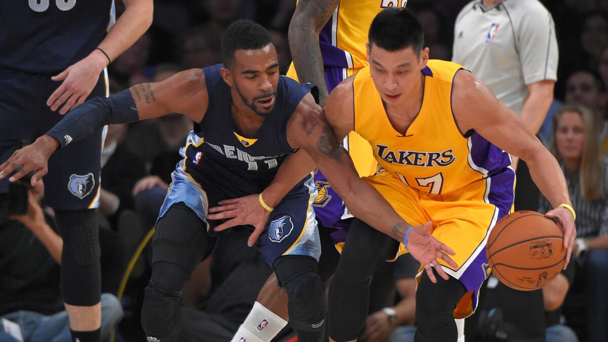 Memphis Grizzlies guard Mike Conley, left, harasses Lakers guard Jeremy Lin during a game on Nov. 26 at Staples Center.