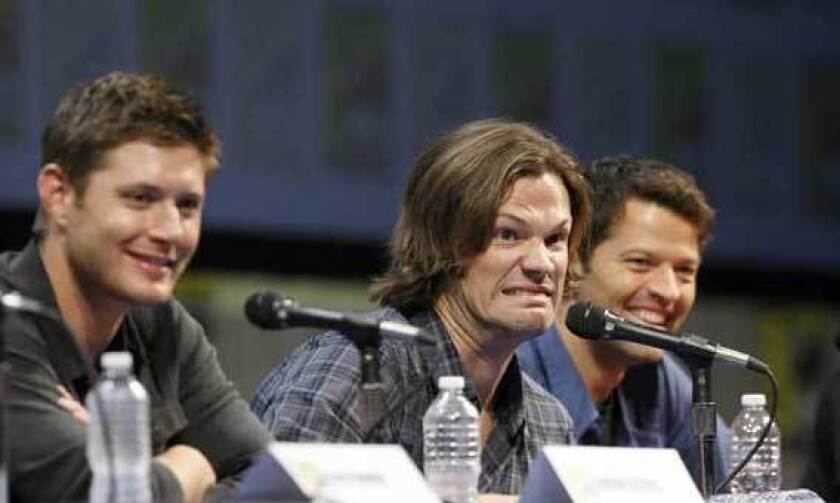 Jared Palalecki jokes with the audience when a question is asked of Jensen Ackles, left, during the "Supernatural" panel at last summer's Comic Con in San Diego. Also present is Misha Collins.