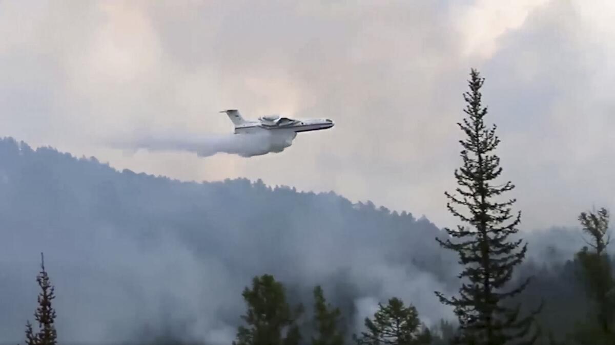 A Russian air tanker drops water on a fire in Siberia.