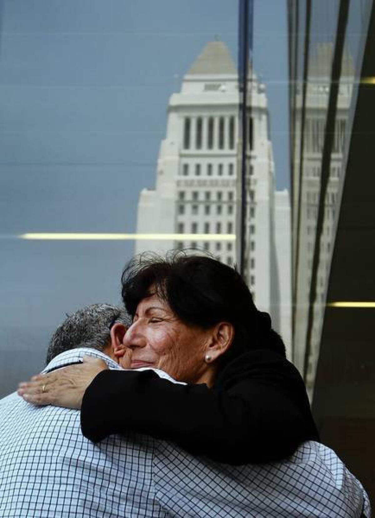 Julie Butcher gets a hug during a 2010 news conference where a reward for information on the slaying of her son Matthew was announced. Two men were sentenced to life in prison Friday after being convicted of his murder.