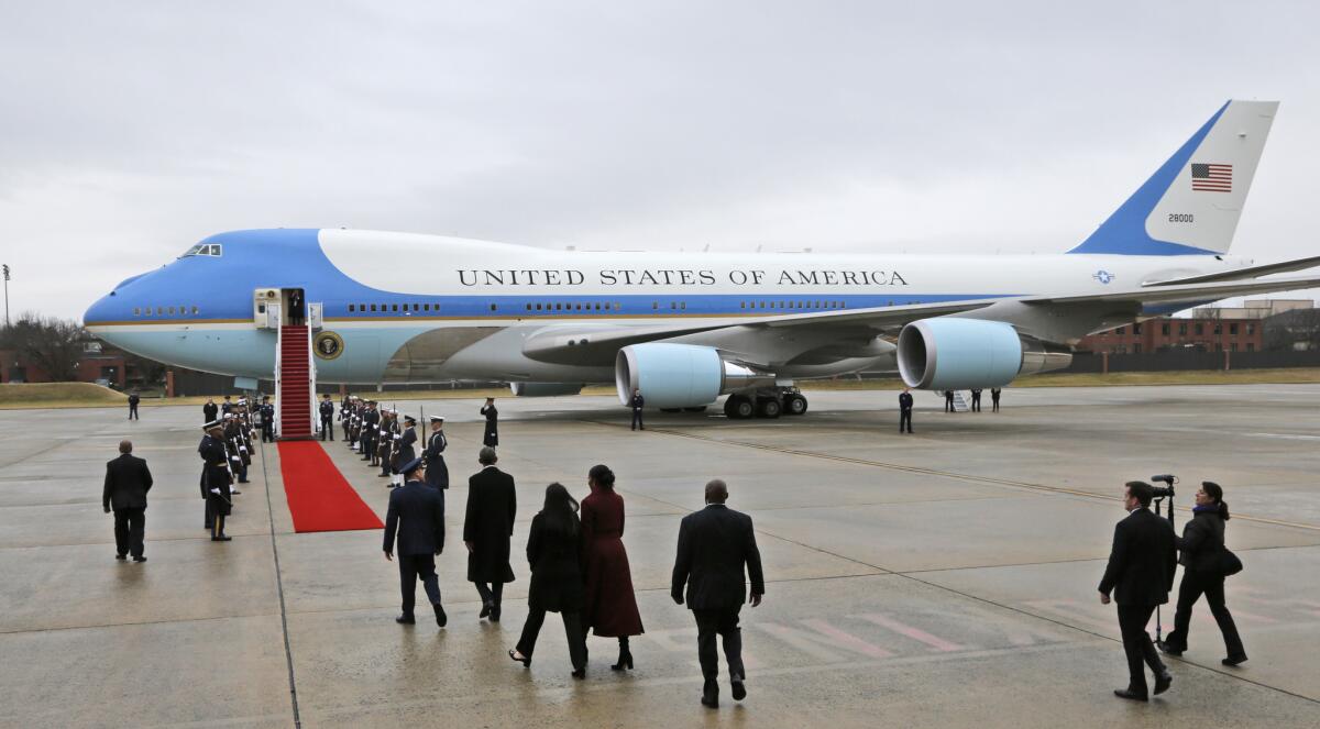 Former President Barack Obama and his wife, Michelle, on Friday prepare to board a plane at Andrews Air Force Base in Maryland for a flight to California.