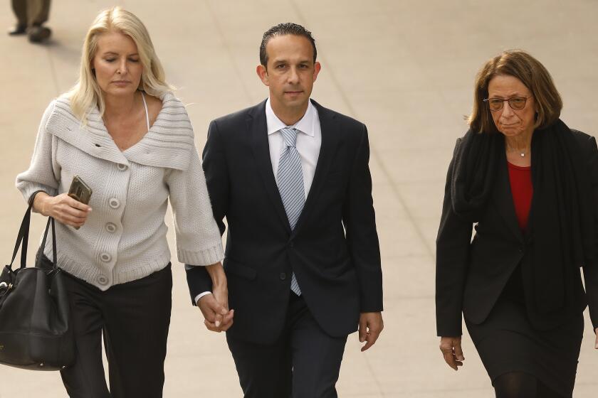 LOS ANGELES, CA - MARCH 12, 2020 Former Los Angeles city councilman Mitchell "Mitch" Englander, walks with his wife Jayne Englander, left, and his lead attorney Janet Levine, right, as they exit the Load Angeles Federal Courthouse after her appeared for a trial-setting conference Thursday morning March 12, 2020. The former Los Angeles city councilman is accused of obstructing an investigation into his allegedly accepting gifts from a businessman during trips to Las Vegas and Palm Springs and he faces seven federal criminal counts -- three of witness tampering, three for allegedly making false statements and a single count of scheming to falsify facts. (Al Seib / Los Angeles Times)