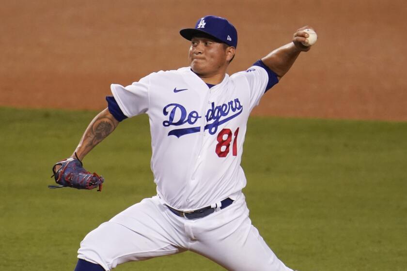 Los Angeles Dodgers relief pitcher Victor Gonzalez works against the Arizona Diamondbacks.