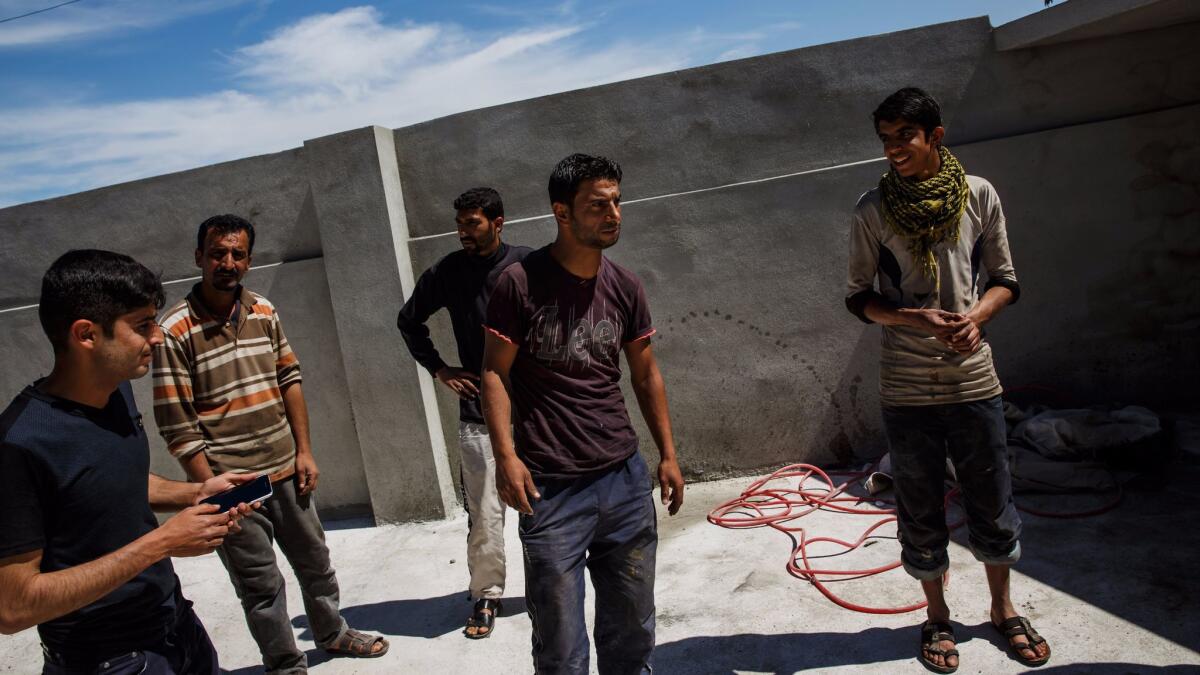 Raed Mohammed Hasan, center, recounts the Jan. 17 airstrike that he said killed 11 people in his home in Mosul, Iraq.