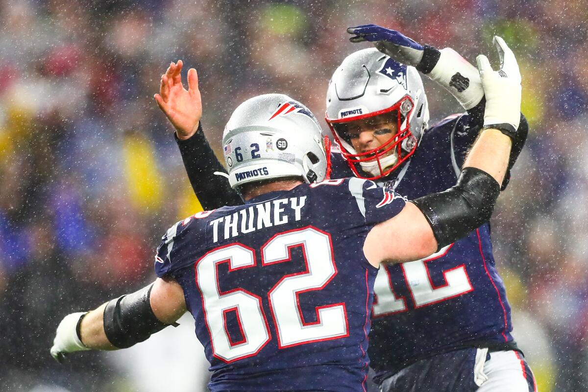 New England Patriots quarterback Tom Brady celebrates with offensive lineman Joe Thuney.