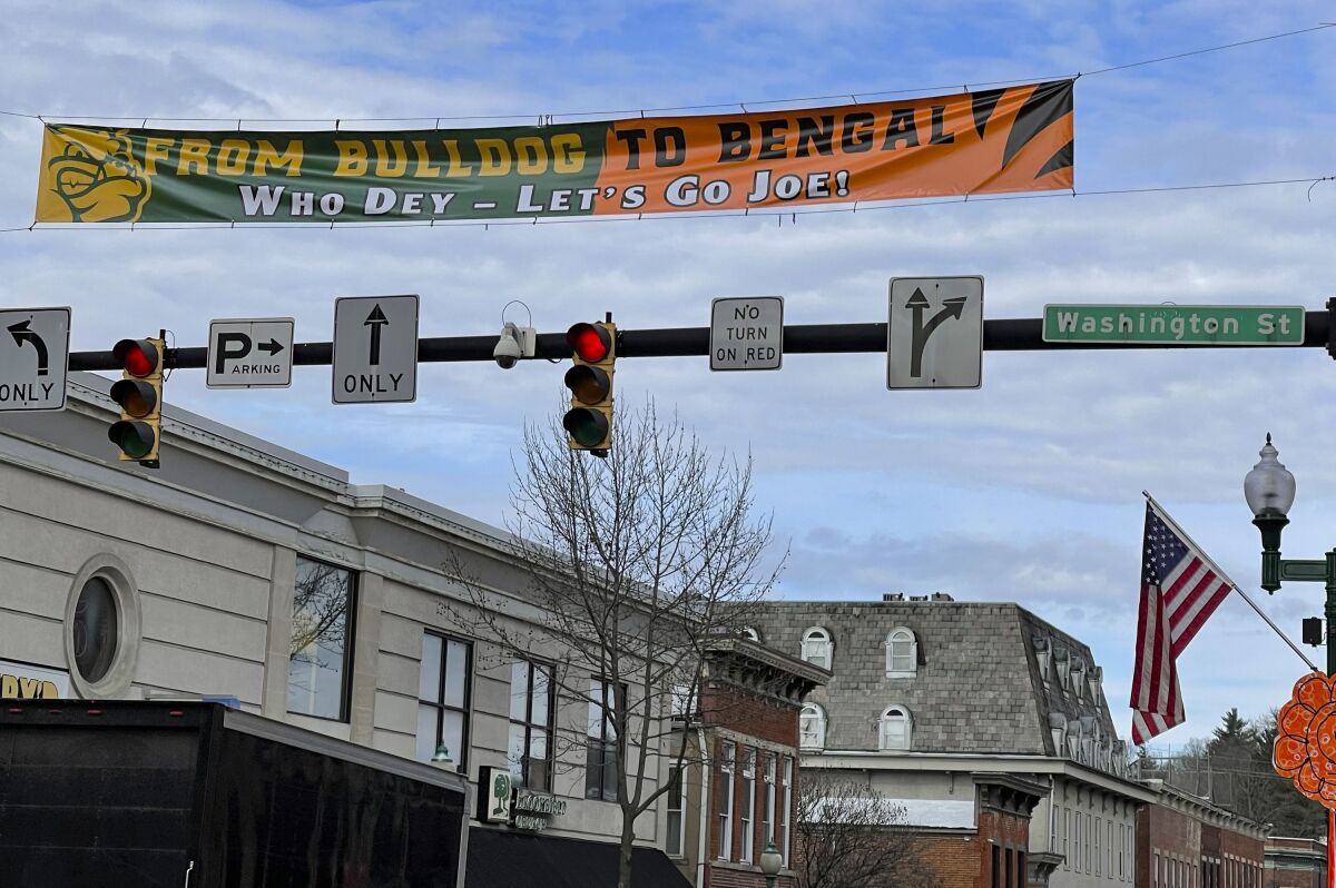 A banner stretched across Court Street in uptown Athens, Ohio, recognizes Joe Burrow's ascension from Athens High School star to Super Bowl quarterback for the Cincinnati Bengals, Wednesday, Feb. 9, 2022. Burrow, who grew up in the nearby village of The Plains, will lead the Bengals against the Los Angeles Rams in the Super Bowl on Sunday. (AP Photo/Mitch Stacy)