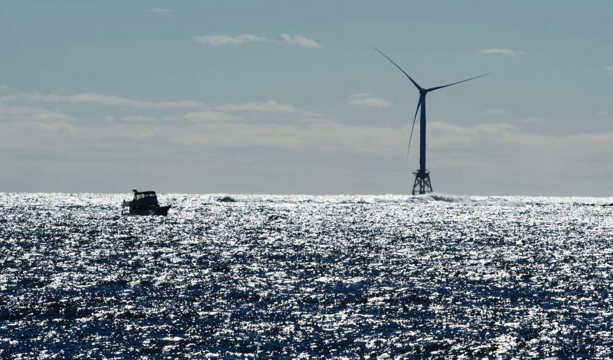 A boat passes one of the wind turbines at the U.S.'s first offshore wind farm, off the shores of Block Island, R.I., in 2016.