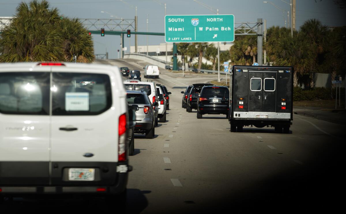 The presidential motorcade drives through West Palm Beach on Saturday.